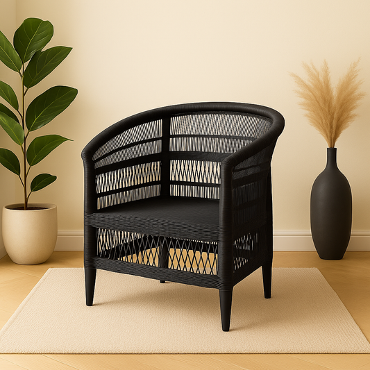 Black woven armchair in a room with a plant and vase on a beige rug.