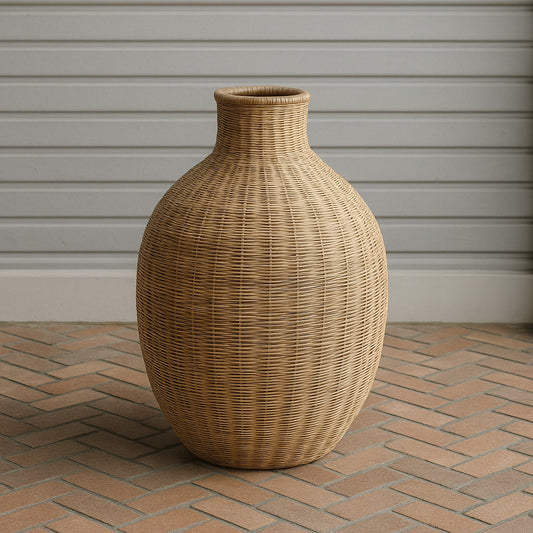 Natural handwoven Malawian vase with rounded silhouette on brick floor background
